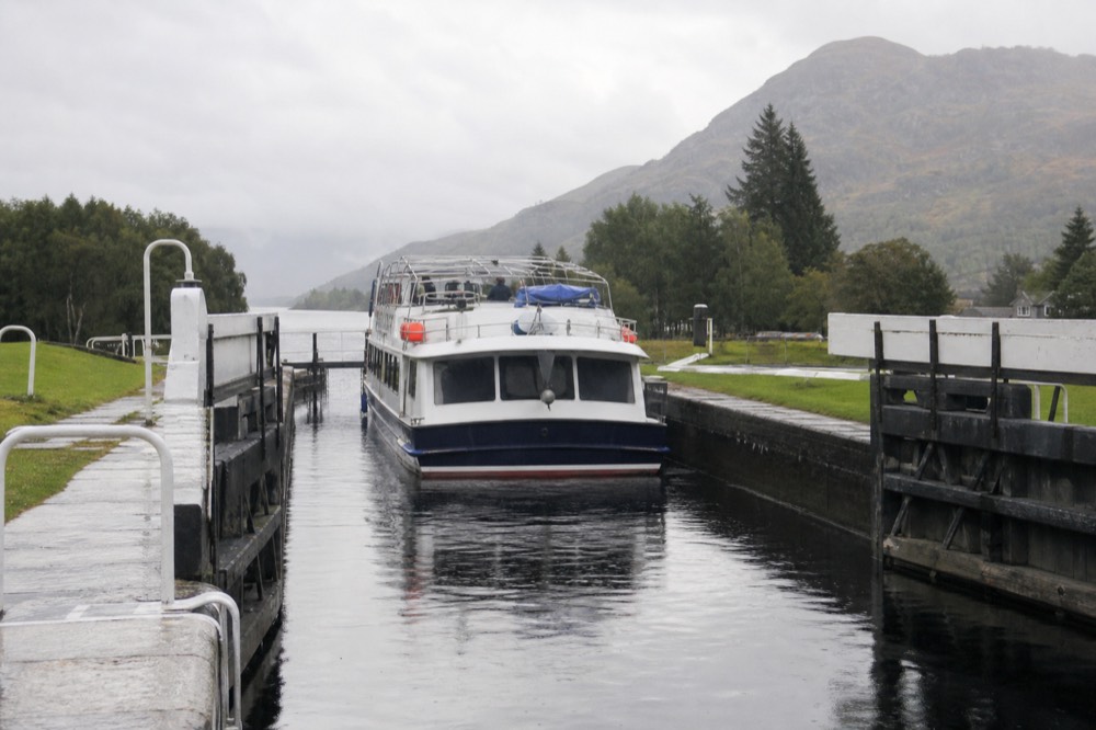 Cruise boat passing through the Caledonian Canal lock at Dochgarroch on the way to Loch Ness