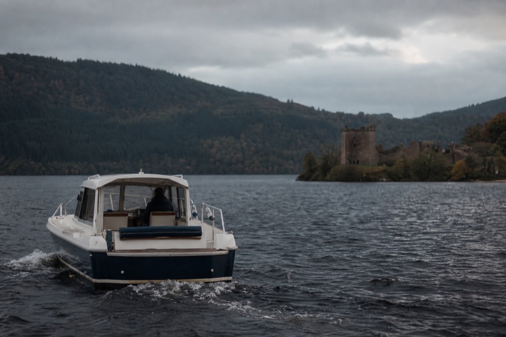 Small private charter boat with its own skipper on Loch Ness near Urquhart Castle